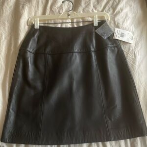 Leather knee-length skirt.